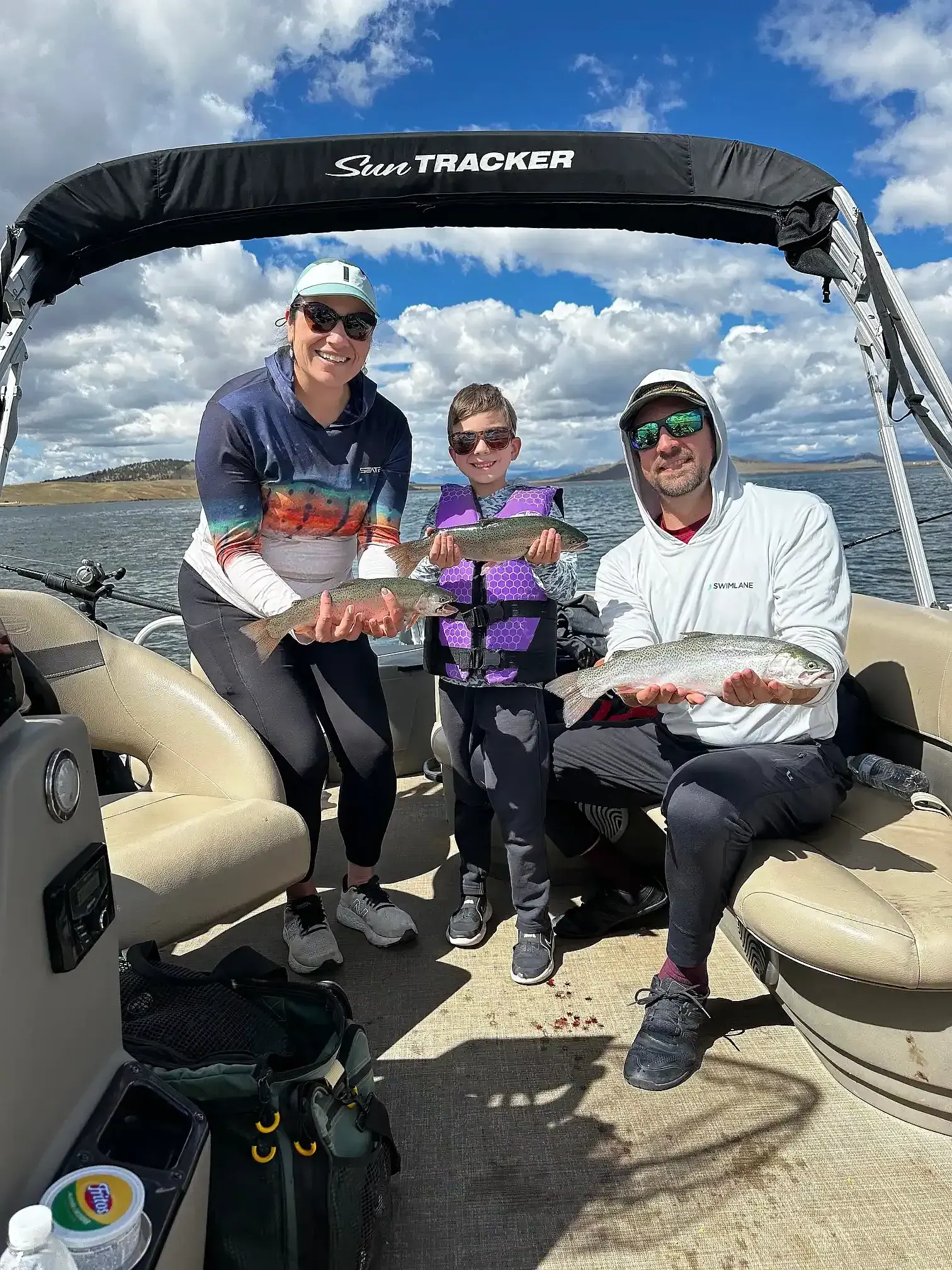 A family of three with their catch aboard the pontoon