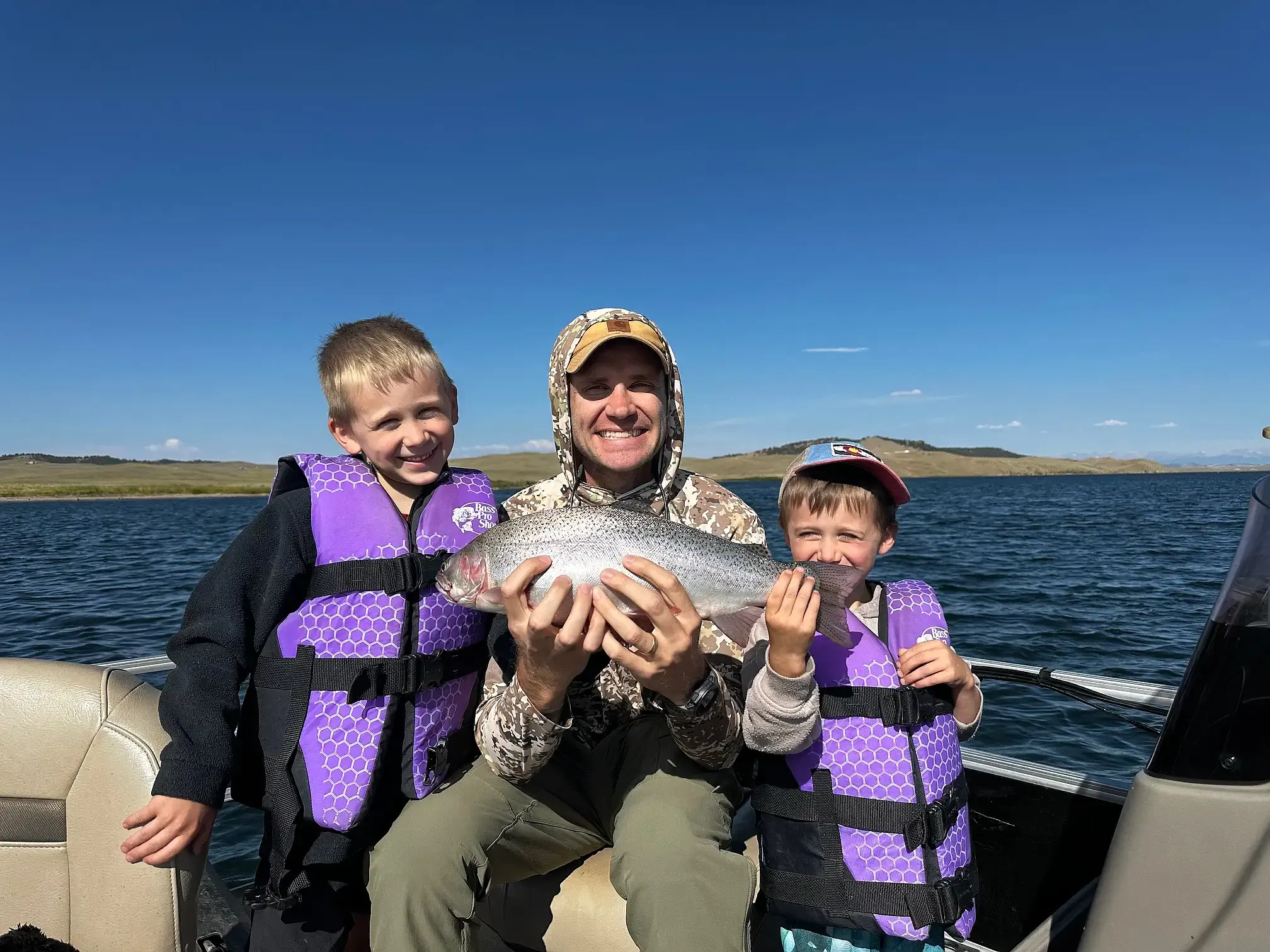 A father and his two sons on the water at Eleven Mile Reservoir